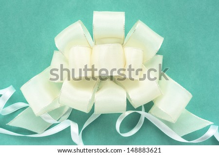 White ribbons on green background. Decking out in white ribbons.
