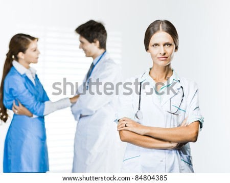 Medical Woman  on white background and medical  man and woman talking behind her