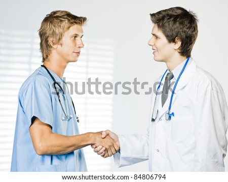 Two medical people handshaking at office