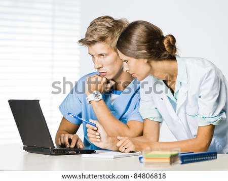 doctor and nurse at computer desk