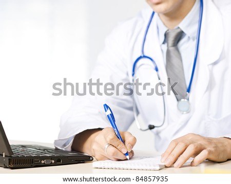 Doctor at his desk close up