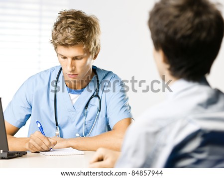 doctor and patient at doctors desk