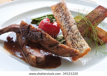 Gourmet dish of grilled duck breast with a sophisticated garnish at the luxury French restaurant
