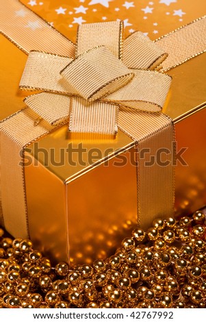 Golden Christmas gift box with a bow