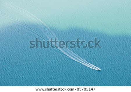 lonely boat on the blue water