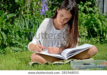 Little Hispanic Girl Draws in an Urban Garden