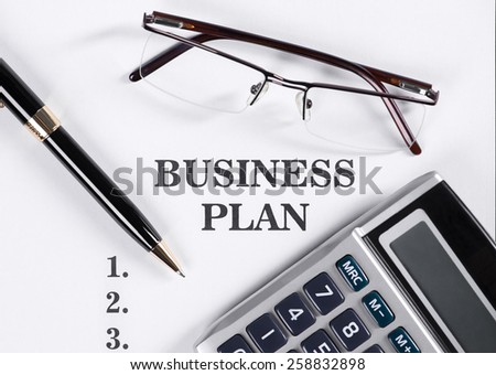 Business Plan with reading glasses, pen, calculator