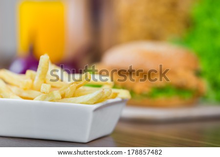 French fries chicken burger on the background