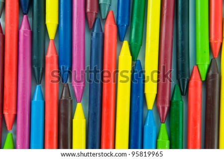 Many colorful wax crayons in a row