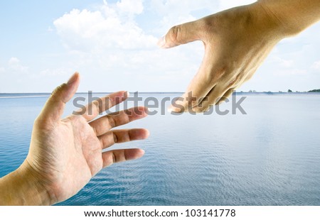 A hand help from another hand. This image ideas for a rescue, safety, religious or support concept.