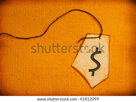Close up of handmade paper tag with Dollar mark