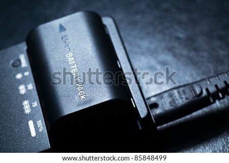 Close up of rechargeable lithium-ion battery with charger