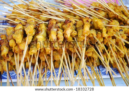 Grilled chicken skewered on bamboo sticks