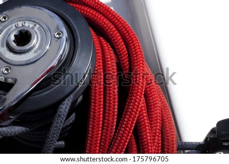 Winch and red rope of a sail boat / Sail boat
