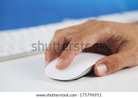 Human hand clicking on a computer mouse / Computer mouse in hand