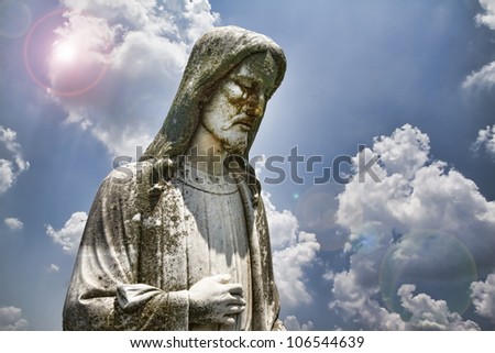 Statue of Jesus Christ with sky background/Jesus Christ the Light of the World/Statue of the Lord Jesus Christ with cloudy blue sky and sun flares
