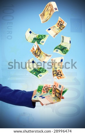 A view of an outstretched arm and hand holding money which falling from sky. Isolated on gradient background.