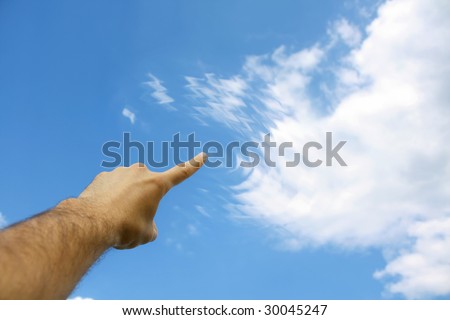 Close up of human finger appearing to touch clouds with ripple like wave effect.