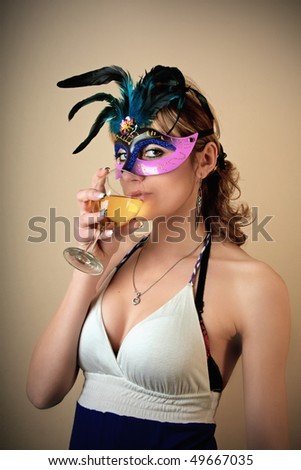Party girl with mask and holding glass of vine portrait