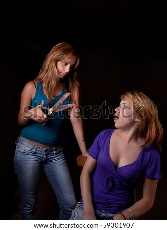 Weird hair-stylist with big scissors on black background and scary girl