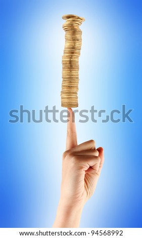 Business metaphor, golden coins balanced on human finger