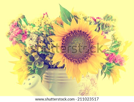 Yellow sunflowers and colored wild flowers in a white sprinkler, close up, isolated, cutout, vintage style