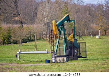 Oil pump in green nature, oilfield in Croatia