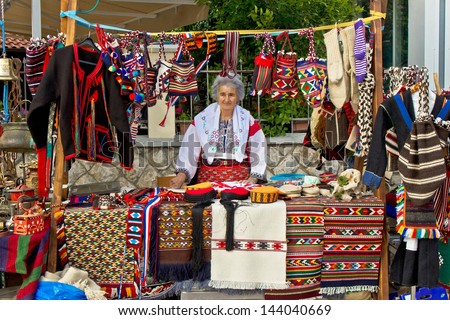 BIOGRAD - MAY 31: Unidentified  lady in traditional clothes selling traditional Croatian clothes on booth at Biograd street fair, on May 31, 2013 in Biograd, Dalmatia, Croatia.