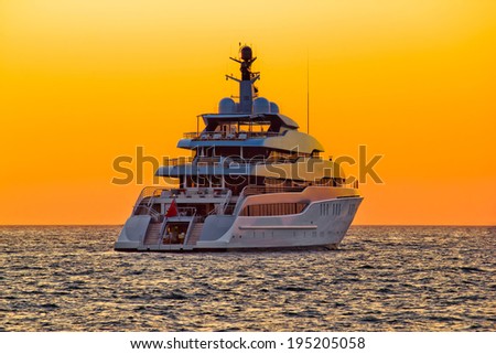 Luxury yacht on open sea at golden sunset