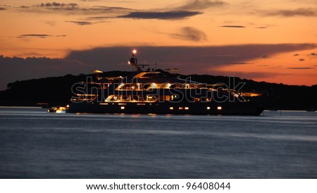 Illuminated luxury yacht at dusk on sea