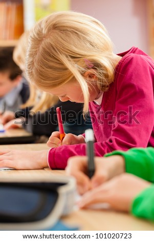 Education - Pupils at primary or elementary school doing their homework or having a school test