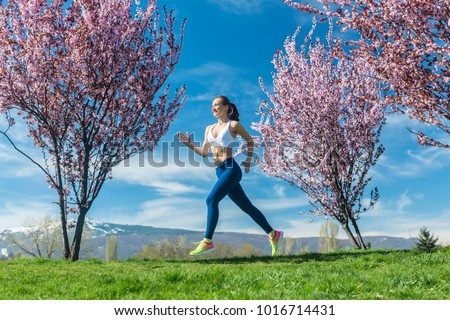 Woman running for fitness on a sunny spring day