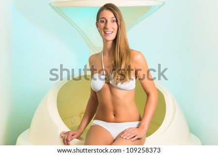 Wellness - young woman floating in Spa or swimming pool, next to her the floating bathtub