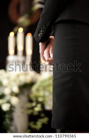 Religion, death and dolor  - woman at urn funeral mourning the death of a loved person