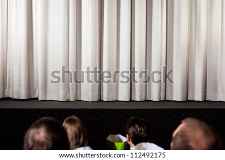 People in the cinema waiting for the movie to start