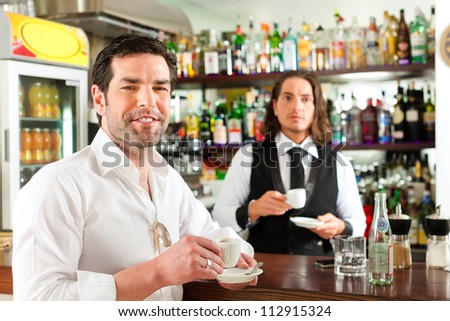 Coffeeshop - barista in cafe with a client, he is drinking coffee, the waiter too