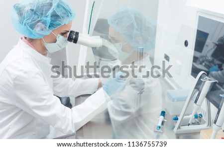 Doctor or scientist working on biotech experiment in laboratory