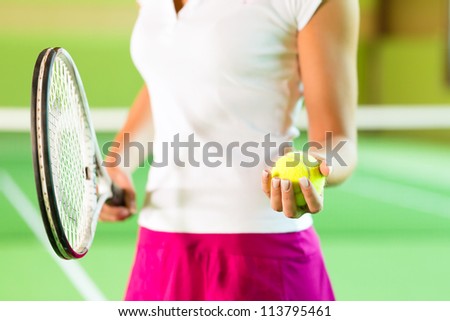 Woman, only upper body with racket and ball, playing tennis giving service