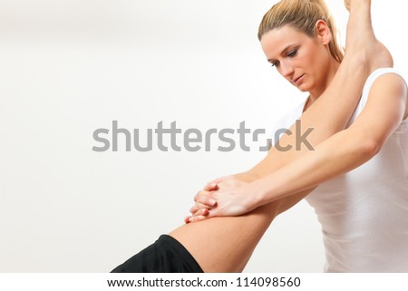 Patient at the physiotherapy doing physical therapy exercises with his therapist