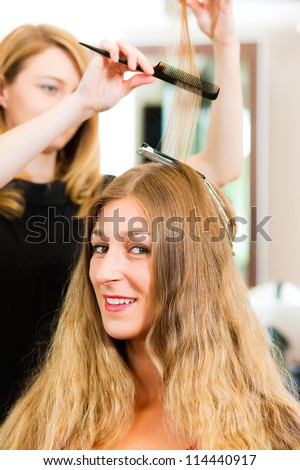 At the hairdresser - woman gets new hair colour or highlights