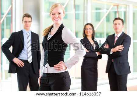 Business - group of businesspeople posing for group photo in office