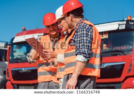 Driver and booker of heavy transport cargo company talking