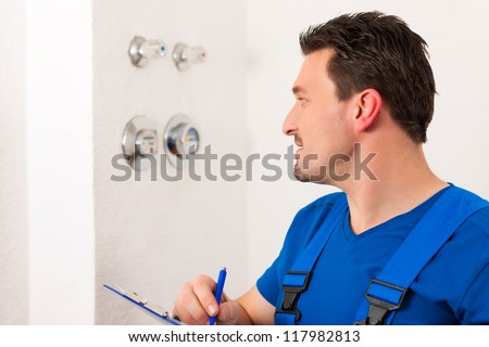 Technician reading the water meter to check consumption