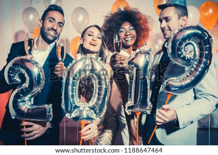 Party people women and men celebrating new years eve 2019 with sparklers and Champagne