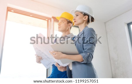 Project owner and construction worker during acceptance checking quality of work