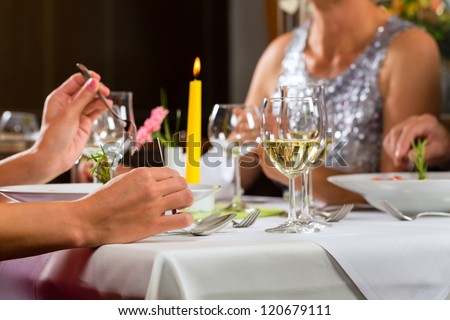 People fine dining food at table in hotel or elegant restaurant