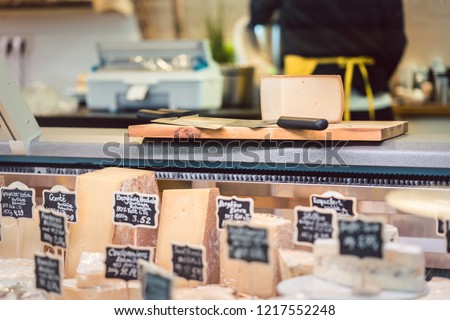 Cheese at the deli counter waiting to be sold