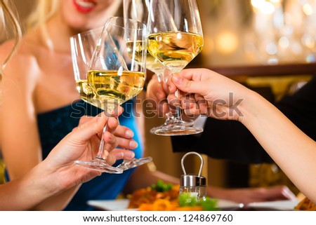 Good Friends For Dinner Or Lunch In A Fine Restaurant, Clinking Glasses
