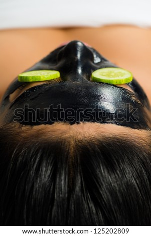Young Asian Woman in a beauty spa getting a treatment with mask to bleach the skin
