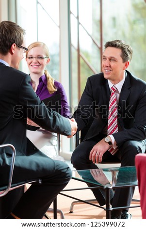 Man having an interview with manager and partner employment job candidate hiring resume CEO work business shaking hands